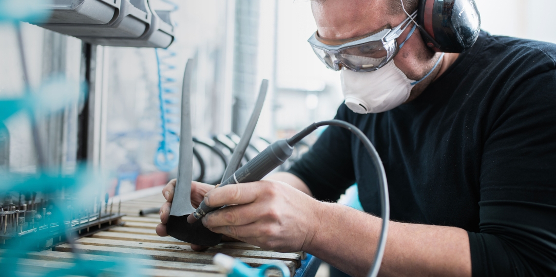 Mitarbeiter von ax-lightness mit Schutzkleidung beim Schleifen